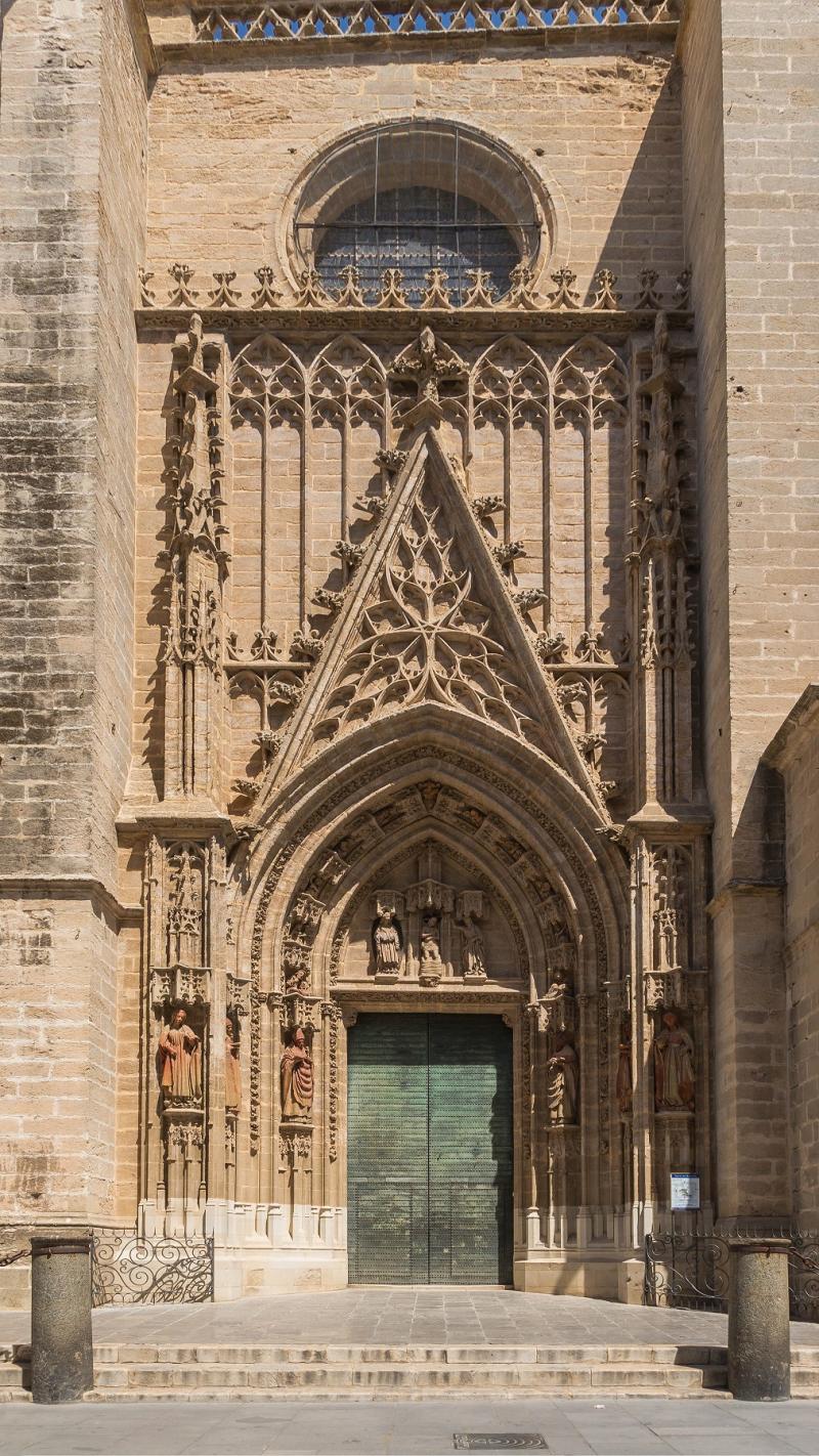 Gate of Baptism at the Cathedral of Seville (Spain), with tympanum depicting the baptism of Jesus, and statues of saints (Isidoro and Leandro, Justa and Rufina, Florentina an Fulgencio)