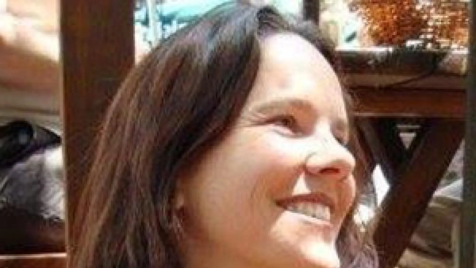 Color image of Jessica Delgado who has lighter skin and long dark hair. Her face turned to the right.