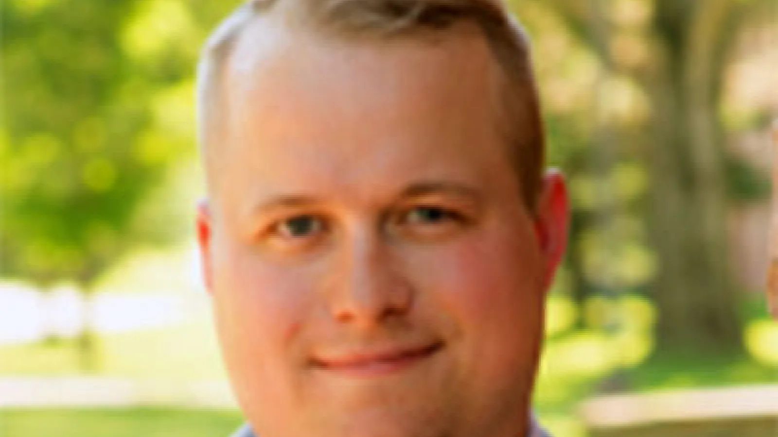 Color headshot image of Travis Proctor who has light skin and light hair.