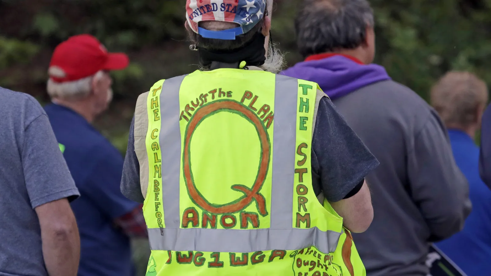 Color photograph of hand-drawn QAnon language in yellow vest
