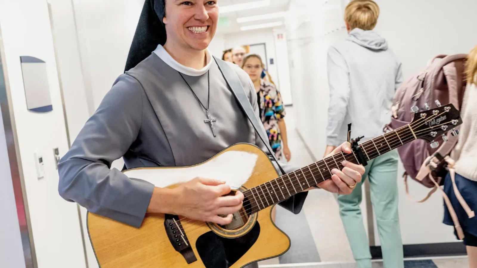 Sister Schulze playing guitar 