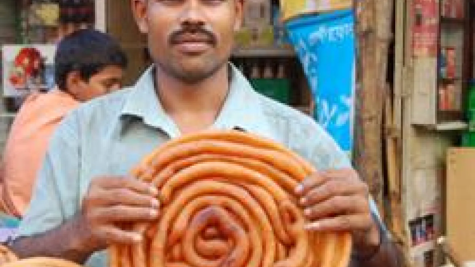 A person holding a breaded pastry