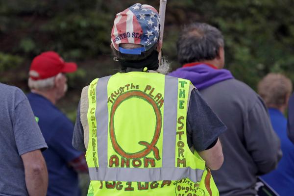 Color photograph of hand-drawn QAnon language in yellow vest